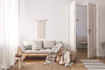 Artisan and natural decorations and accessories in a warm living room interior with wooden...