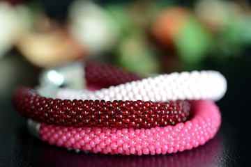 Set of three beaded bracelets on a dark background close up