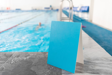 Empty blue sign near the swimming pool.