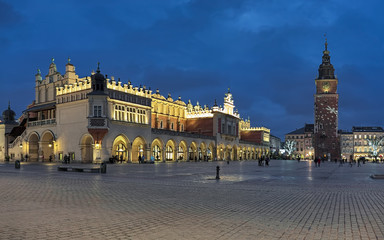 Fototapeta premium Krakow, Poland. Main Market Square (Rynek Glowny) with Cloth Hall (Sukiennice) and free-standing Town Hall Tower in Christmas illumination.