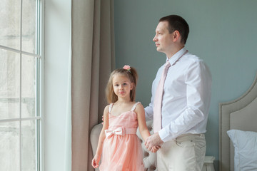 Father and young daughter together at home