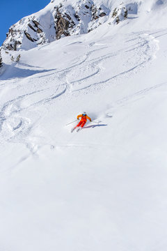 freeride skier skiing downhill, facing forward, white snowy background