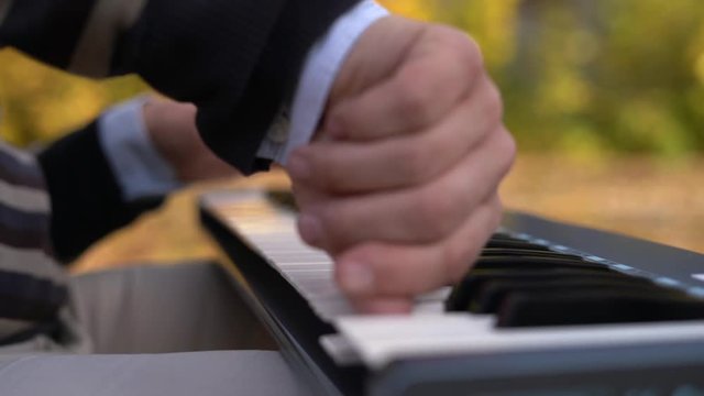 Closeup Of Male Hands Playing Piano. Man Playing The Synthesizer Keyboard