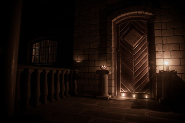 Front door to a house decorated with Halloween pumpkin. Halloween pumpkin on a door steep