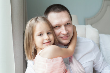Father and daughter hugging, portrait