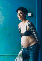 Fototapeta na wymiar A beautiful pregnant woman. Fashion shot of a pregnant woman