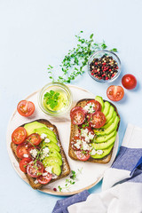 Avocado tomatoes goat cheese sandwiches. Top view, space for text.
