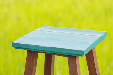 Brown wood chairs and blue sea on green background. It is used for sitting or placing objects. Soft focus and Copy space. For texture.