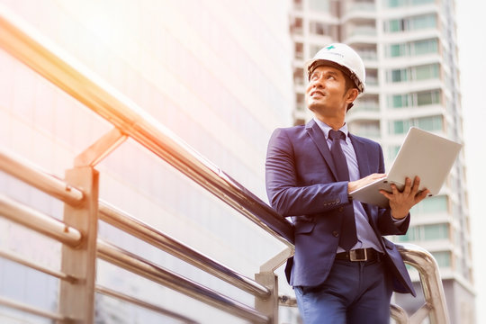 Senior engineer man in suit and helmet working on tablet pc - Powered by Adobe