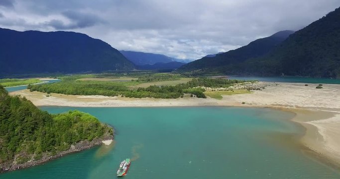 Aerial view of the landscape surrounding the tagua tagua lake, a barge is observed crossing the lake