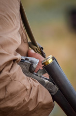 Hunter hold a double-barreled gun. Hunting season.