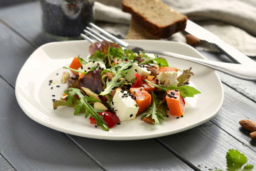Pumpkin salad with feta, sweet pepper, fresh herbs, almonds and sesame