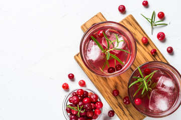 Cocktail with cranberry, vodka, rosemary and ice.