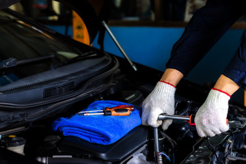 A mechanic Check the oil. Work equipment such as glove.Concept Service by car..