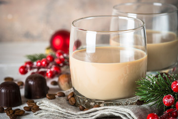 Irish creme liqueur in glass with christmas decorations.