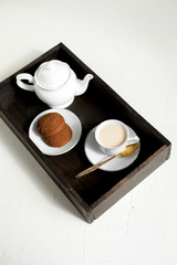 Breakfast, wooden tray of tea and oatmeal cookies