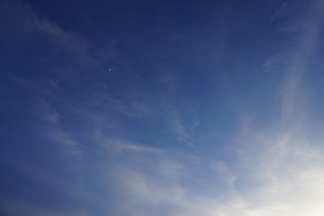 blue sky with clouds and little moon.