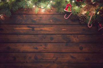 Christmas garland with ornaments on the old wooden background - 229192242