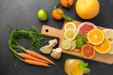 food , healthy eating and vegetarian concept - close up of fruits, vegetables, wooden cutting board...