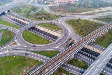 Aerial view of highway intersection with roundabout and railroad