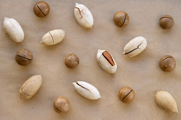 macadamia, Brazil nuts, Bertholletia, pecan on brown wrapping paper. roasted and notched exotic shell nuts background.