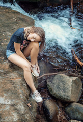 Sad woman sitting by the river