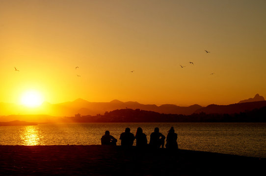 silhouette of people at sunset