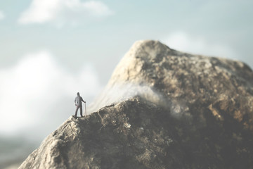 man reach the top of the mountain