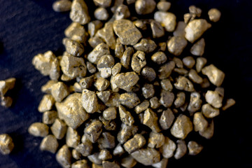 Top view of golden sand at black board.