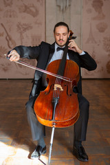Young man playing the cello. Portrait of the cellist © biggur