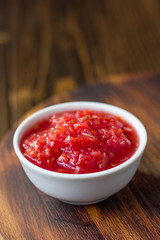 Indian chutney or mexican salsa in white ceramic bowl.