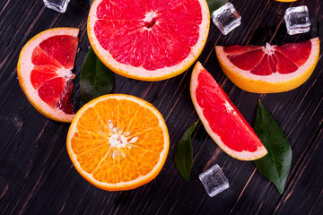 orange and grapefruit juice On a wooden black background