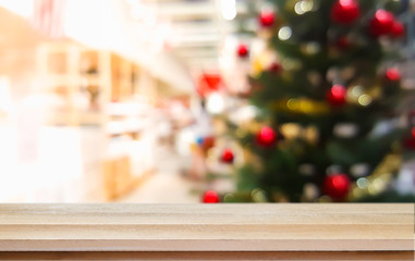 Christmas xmas tree on table wood with festive bokeh light holiday blur background.