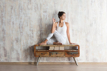 Woman yoga instructor doing asana marichiasana