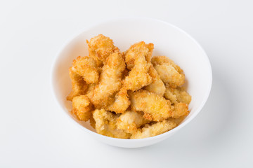 fried chicken nuggets in the white bowl on white background