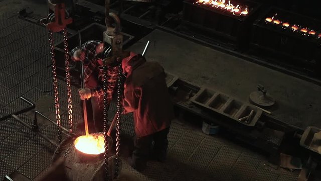 Hard work in the foundry. Working smelted iron in the furnaces. High temperature and dangerous work.