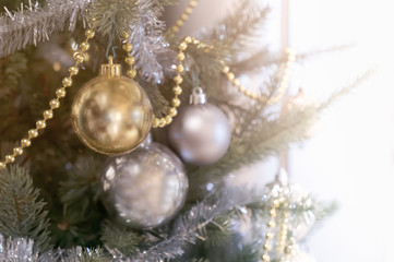 Fototapeta na wymiar Christmas ornament ball decorate on pine tree copy space blur background for Xmas New Year festival.