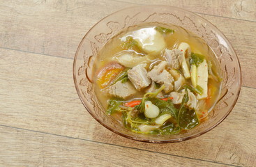 hot and spicy pork bone with tamarind and Thai herbs soup on glass bowl