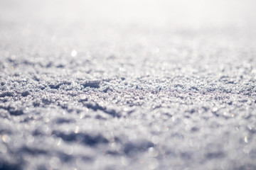 Obraz premium Macro shot of pure white snow with shallow depth of field and pleasant blurry bokeh. Great winter christmas background for your layout