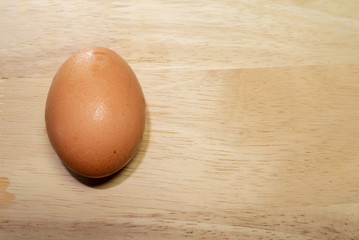 brown egg on wooden background