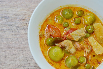 spicy boiled roasted duck meat with pineapple and eggplant in coconut milk curry on bowl