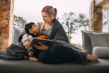 Woman talking with son sitting at home