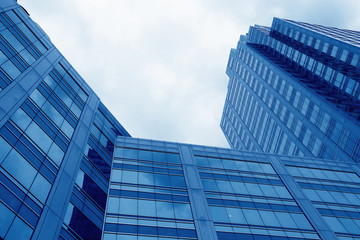 Fototapeta na wymiar Office building business district in blue tone.