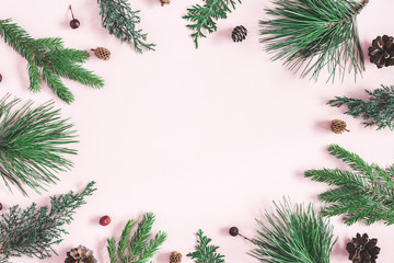 Obraz na płótnie Canvas Christmas composition. Coniferous tree branches on pastel pink background. Christmas, winter, new year concept. Flat lay, top view, copy space
