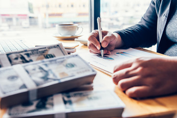 Businessmen are working on dollars, calculating profits and earning results,