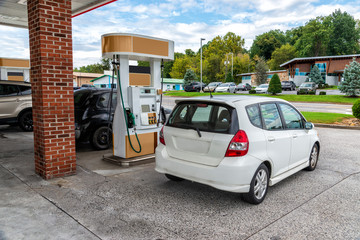 Generic Compact Car Buys Gasoline At Generic Convenience Store