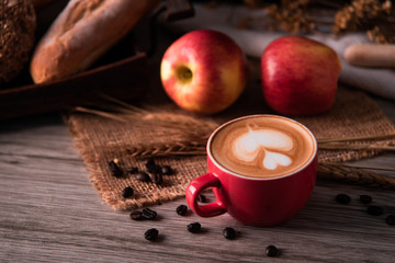 Red coffee glass rests on wood floor. concept still life