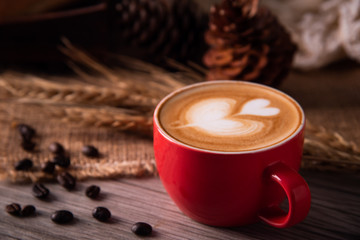 Red coffee glass rests on wood floor. concept still life