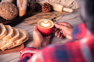 Hand is holding a red cup of coffee. concept still life