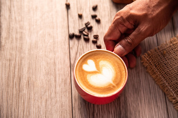 Red coffee glass rests on wood floor. concept still life
